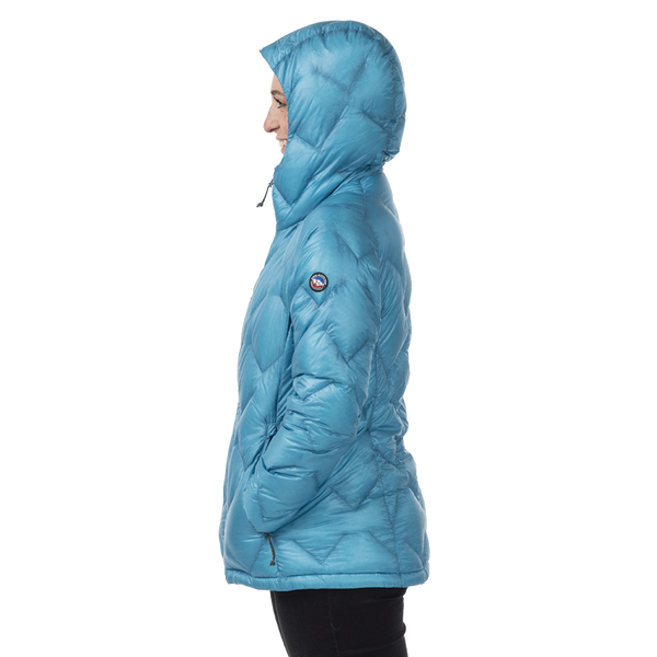 Woman in profile wearing blue geometric patterned hooded jacket