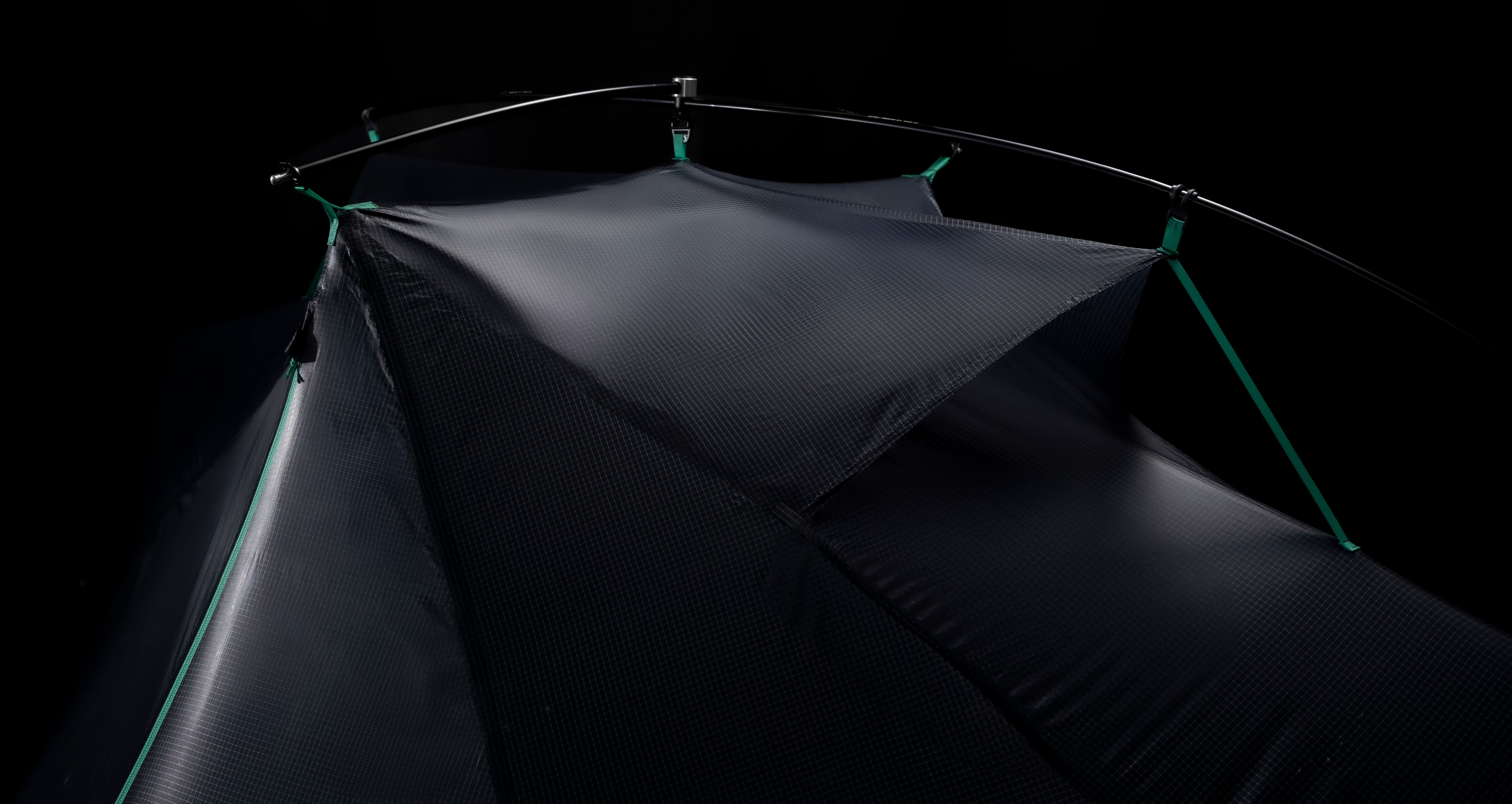 Dark tent with green accents on a black background