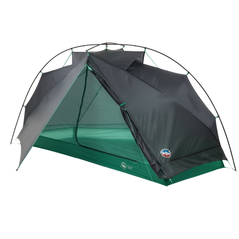 The Big Agnes Pitchpine VST 1.5, a green and gray dome-shaped tent with a mesh door, is displayed partially open on a white background. Made from Hyperbead fabric, this ultralight shelter is ideal for your next adventure.