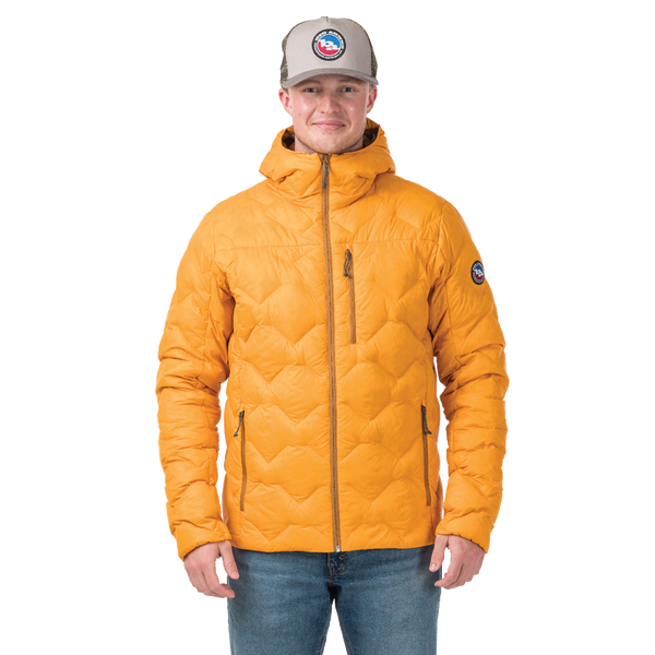 Person wearing a yellow quilted jacket with a brand logo on a white background