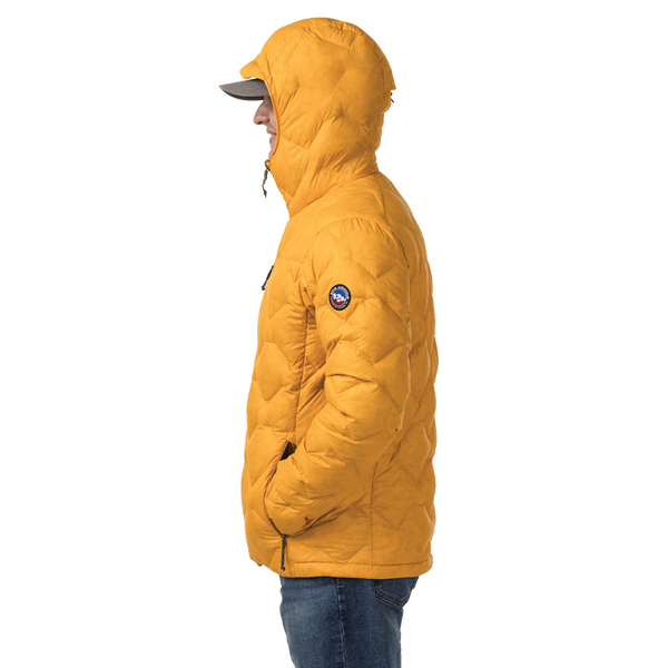 Person wearing a mustard yellow puffer jacket with a brand logo on a white background