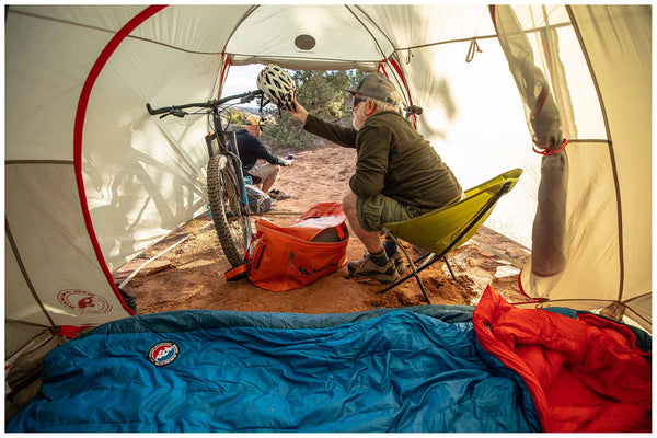 A lightweight, folding Big Agnes Mica Basin chair shown next to its small carrying sack.